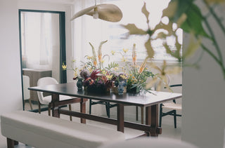 Floral arrangement on a dining table in a bright room
